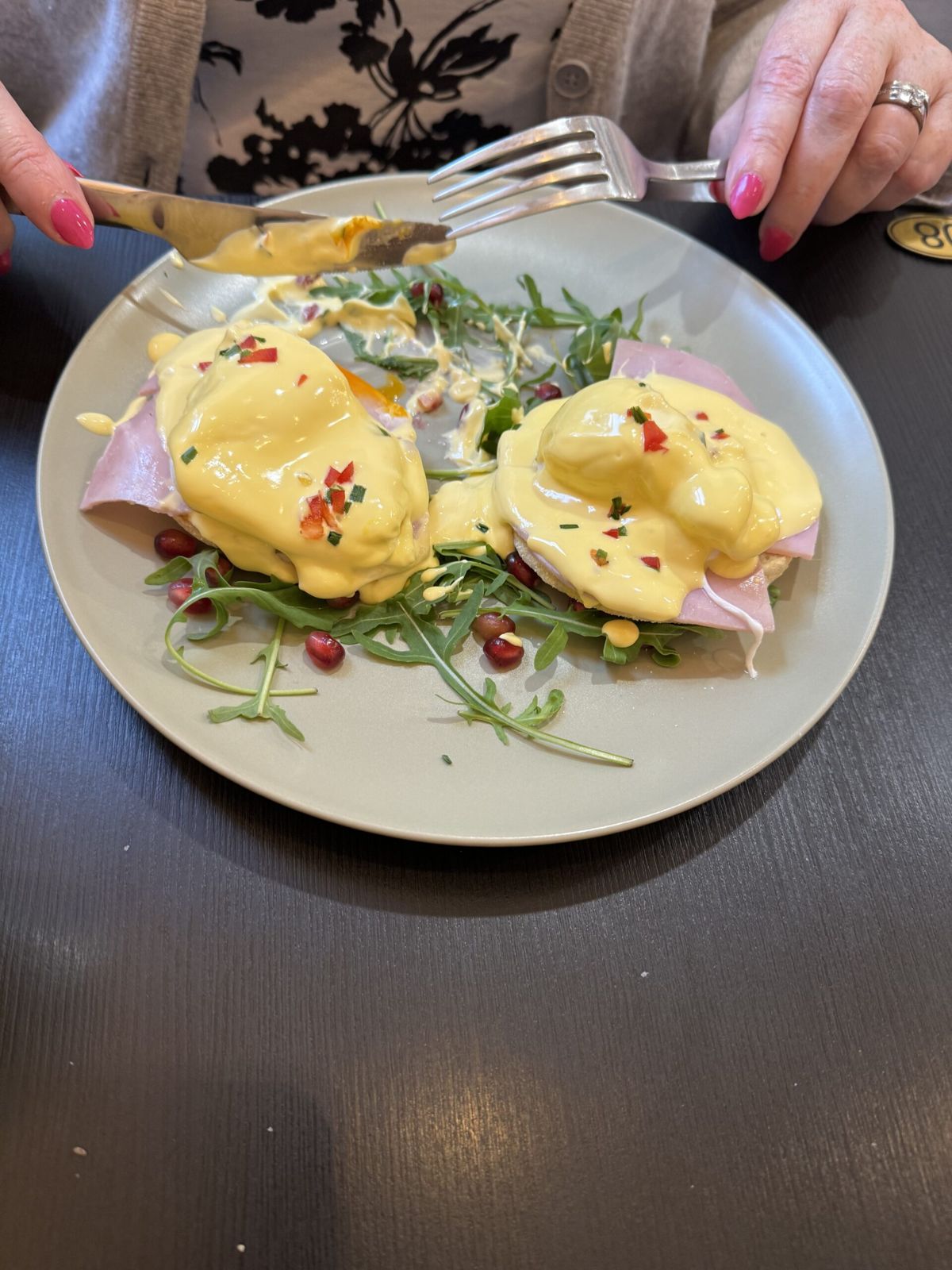 Mardi's eggs Benedict, eggs on a plate with hollandaise sauce and salad.