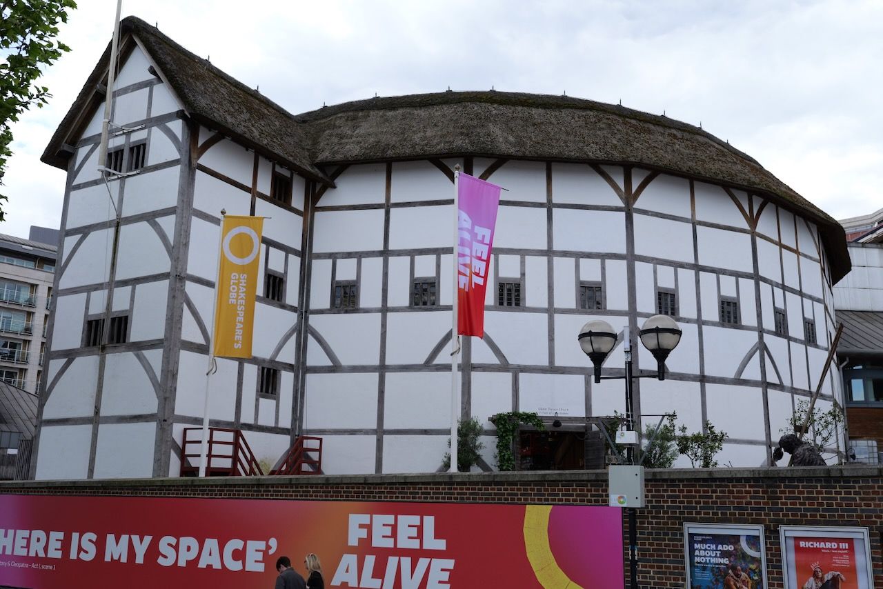 image of the Globe theatre a wooden circular construction about three stories high with a thatched roof