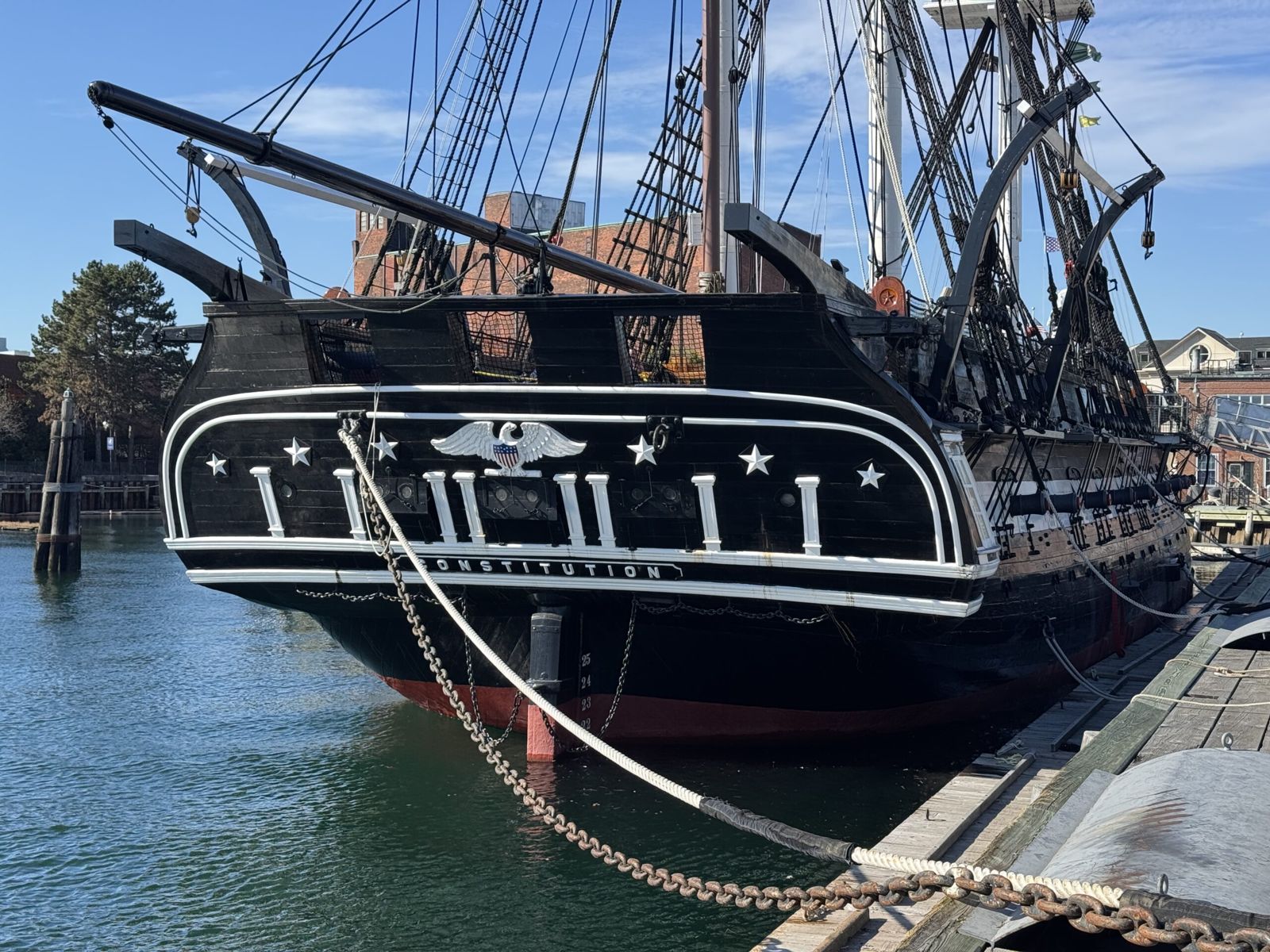 The read of the USA vondtitution. A ship. It’s black and white wooden frame can be seen. 