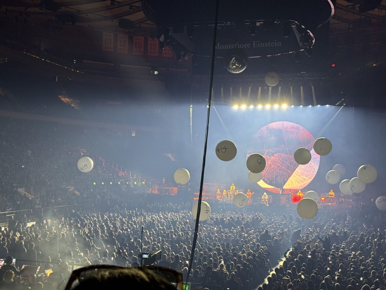 Balls bounce around the crowd st intermission. They are large, about a metre across and are white. 
