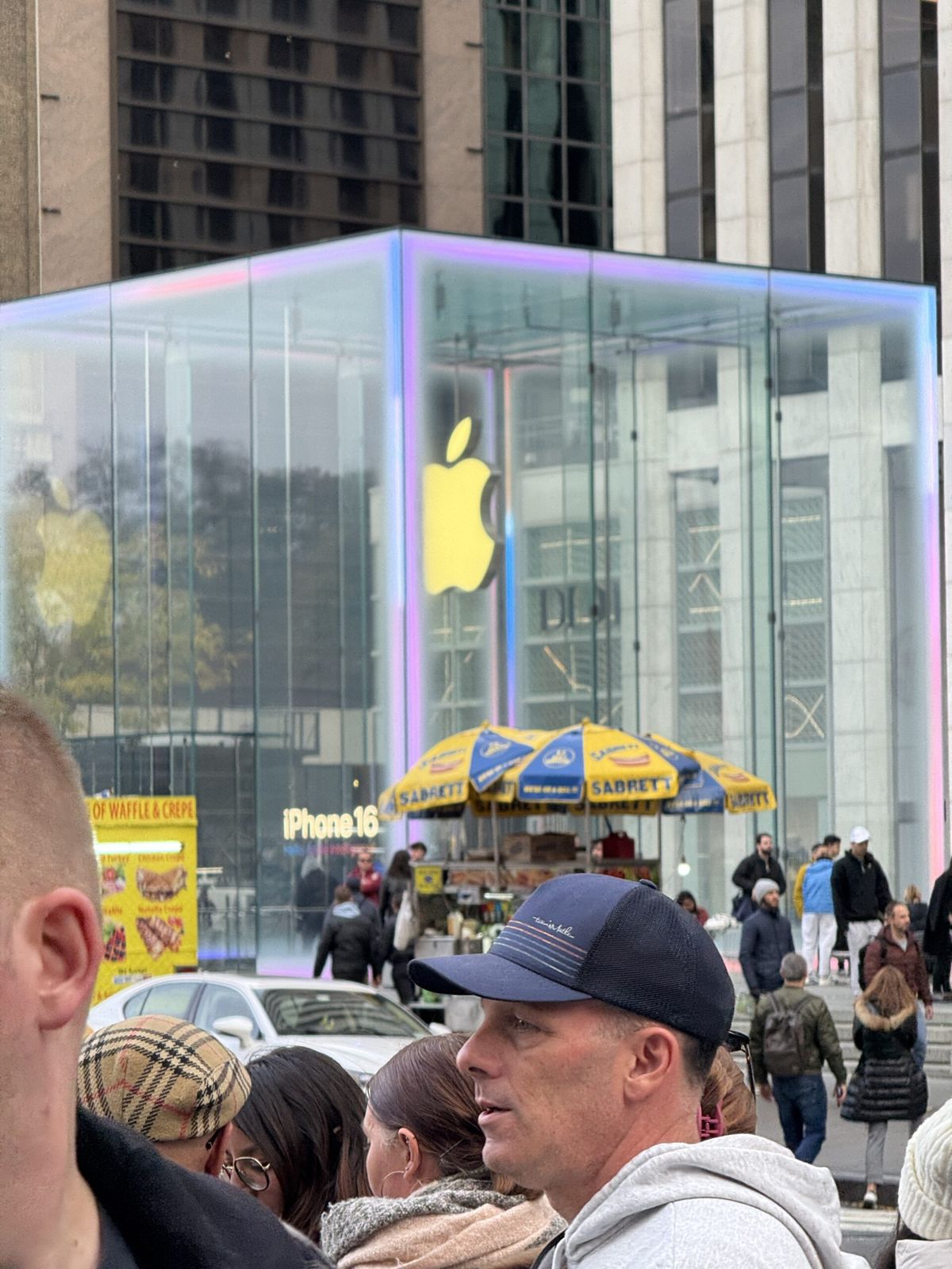 The iconic Apple building on fifth Avenue the entrance to the building a glass Q with the Apple logo on the centre