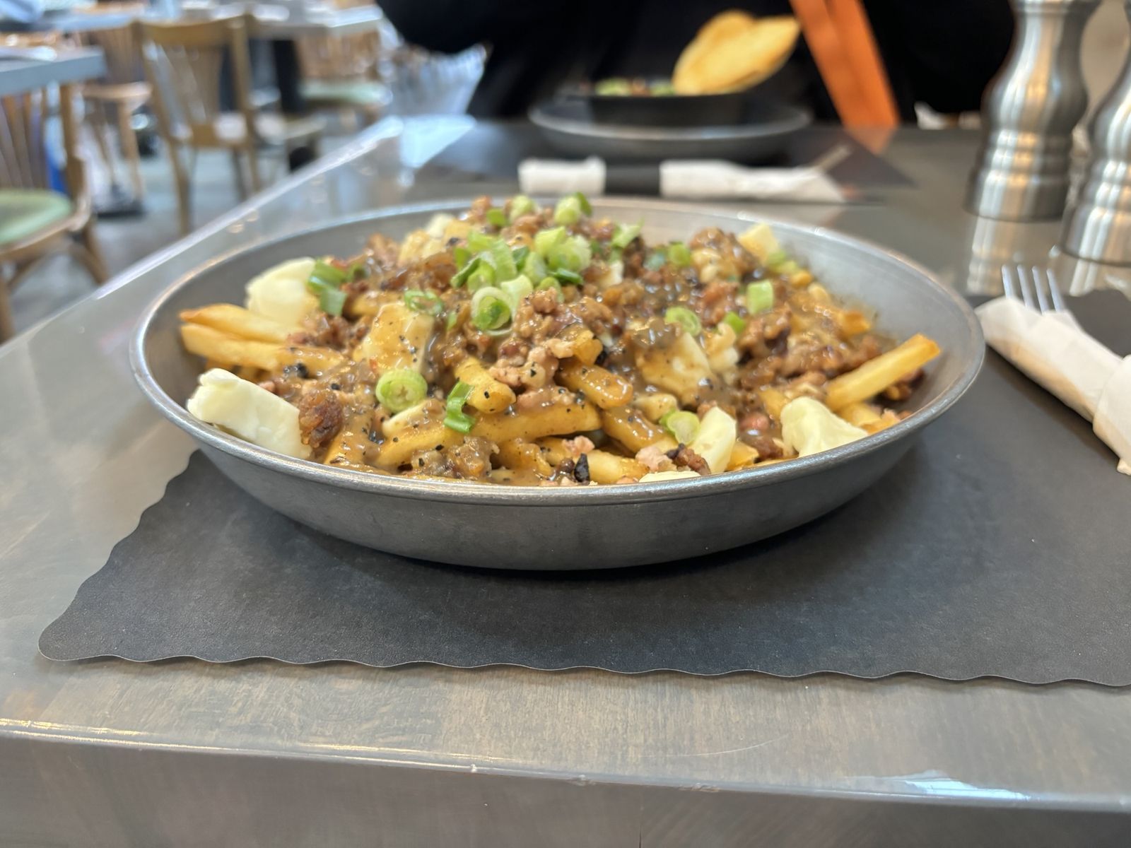 Poutine. A plate of chips, gravy and cheese.